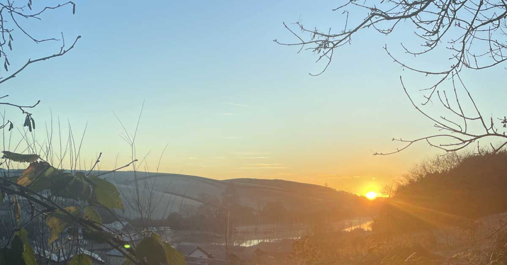 A winter sunrise over Sharpham Estate