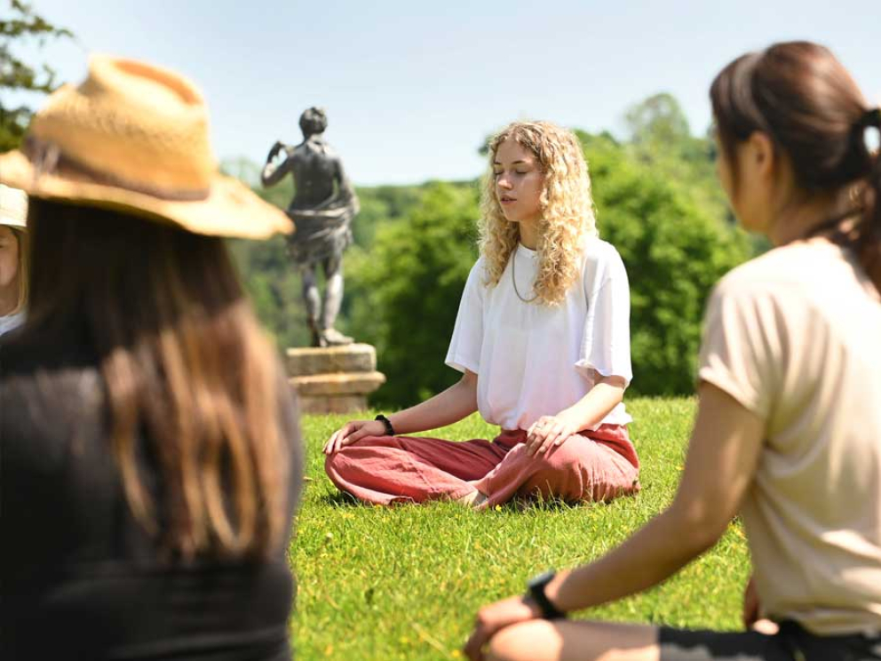 Silent meditation retreat - people sitting in circle meditating